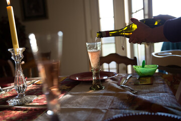 Sparkling wine being poured at table. High quality photo