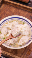 Homemade Wonton Soup with Clear Broth and Dumplings in Traditional Bowl
