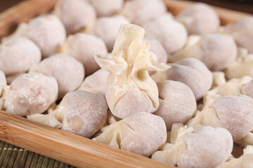 Handmade Wontons with Meat Filling in Bamboo Steamer Ready for Soup