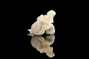 Homemade Meat Wontons on Black Background with Reflection - Traditional Asian Dumplings