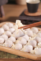 Homemade Ravioli Dumplings in Wooden Steamer with Chopsticks - Fresh Pasta Cooking