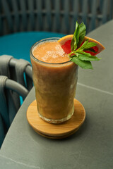 tall glass of grapefruit smoothie