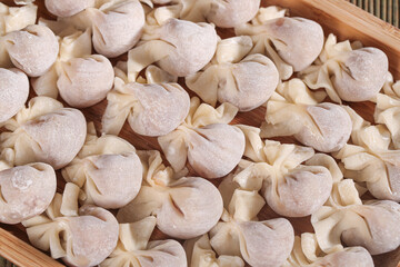 Homemade Wontons and Ravioli Pasta with Meat Filling in Bamboo Steamer Basket