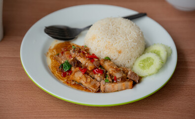 Close up and selective focus stir-fried crispy pork belly and basil with rice - Asian local street food style