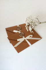 two Gift Certificate envelope with seal and bow, flowers on white background
