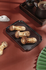 Fresh Shiitake Mushrooms in Black Dish with Traditional Tea Set Asian Cooking Ingredients