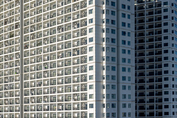 Naklejka premium High-rise apartment buildings with geometric facade in urban setting