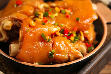 Marinated Pork Trotters in Savory Sauce with Herbs - Traditional Asian Delicacy in Clay Bowl