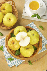 Fresh Dangshan Pears in Wicker Baskets with Herbal Tea - Healthy Organic Fruit Still Life on Wooden Background