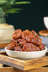 Dried Lychee Fruits from Gaozhou in White Bowl on Wooden Tray - Traditional Chinese Preserved Fruit Snack