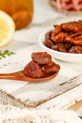 Dried dates on wooden spoon healthy natural snack food sweet flavor lychee osmanthus