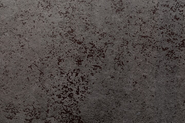 Textured gray concrete surface with subtle patterns and variations in tone captured in natural light