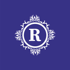 Ornate monogram letter r in floral mandala frame on purple background