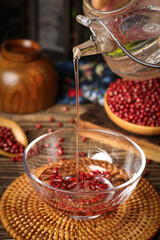 Pouring Hot Tea Over Red Beans in Glass Bowl - Healthy Organic Breakfast Preparation