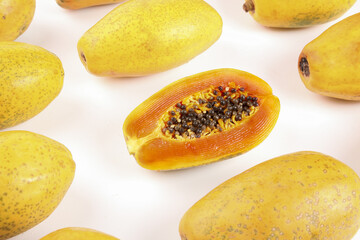 Fresh Ripe Papaya Fruits with Cut Half Showing Seeds on White Background