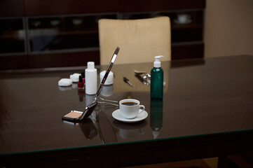 Elegant Work Desk with Coffee, Cosmetics, and Styling Items