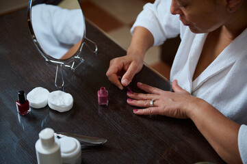 Woman Applying Nail Polish During Personal Grooming at Home