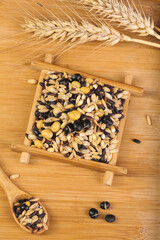 Mixed Grains Soybean Black Bean Peanut Collection in Wooden Bowl with Wheat Stalks on Bamboo Background