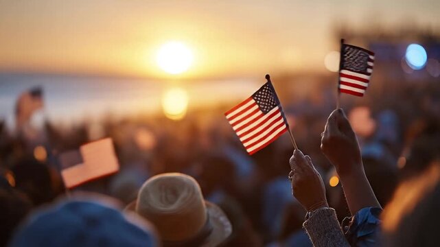 Crowd waves US flags at sunset Hands hold small flags aloft in a patriotic display
