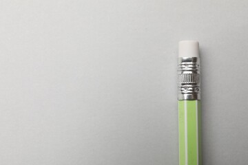 One graphite pencil on grey background, above view. Space for text