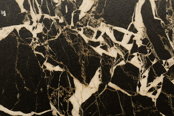 Beautiful black marble surface with white and gold veining patterns showcasing natural elegance and timeless design