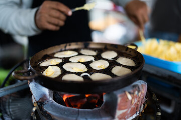 Khanom Khai in hot pan make by Thai trader, Khanom Khai is a Thai oval sweetmeat made with egg and sugar