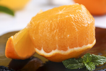 Fresh Orange Segments with Mint Leaves on Wooden Background - Healthy Citrus Fruit