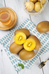 Fresh Golden Kiwi Fruit with Yellow Heart on Light Background - New Zealand Tropical Food Photography