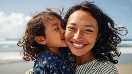 Fototapeta premium Woman hugging child at beach.