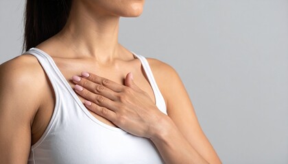 Fototapeta premium Woman Gently Touching Her Chest Wellness Self Care.