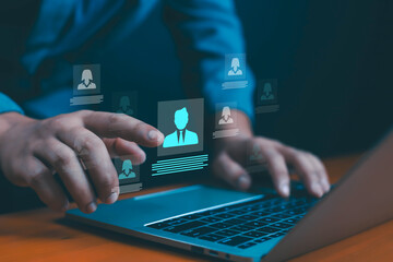 Businessman using laptop with digital profile icons, symbolizing online recruitment, human resources management, candidate selection, job application process, career development, hiring solutions.