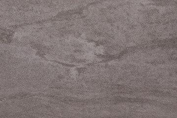 Unique textured surface displaying natural patterns resembling marble from a quarry in late afternoon light