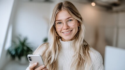 Businesswoman smiling while using smartphone in a modern office setting