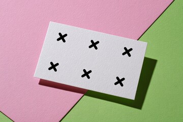 Minimalist graphic design element with tracking markers on pink and green background.