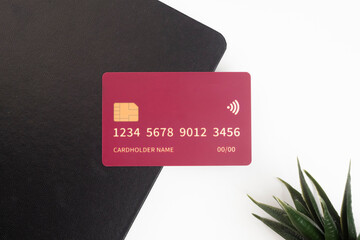 Debit and credit cards are placed on a book. Concept of online shopping and retail payments. Mockup...