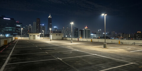 Empty rooftop night city skyline urban parking lights concrete modern architecture panoramic Empty rooftop night city skyline urban parking lights concrete modern architecture panoramic view with