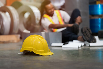 Worker fell down on ground. Worker had accident and broke leg from rolls of metal sheet at metal sheet factory. Industrial accident concept. Health safe of work and safety first © amorn