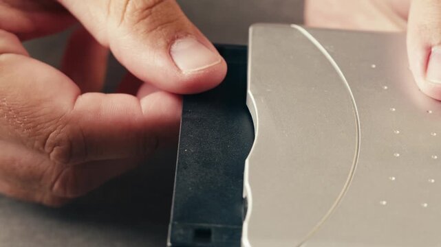 Floppy disc FDD close up, Using diskette for old PC computer macro. Archive programme or Music recorder, playing retro computer games. Vintage device for office, obsolete technology. 
