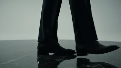 Stylish walk sequence: Low angle shot of confident footsteps on polished surface, elegant movement