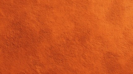 Textured orange concrete wall surface with rough finish