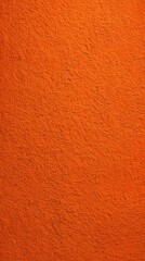 Fototapeta premium Bright orange textured wall surface with rough pattern
