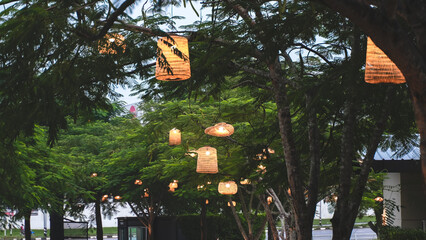 String lights glowing among trees in a lush green garden, creating a cozy and festive outdoor ambiance.