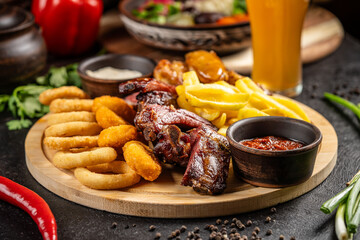Mixed appetizer platter with ribs, fries and onion rings