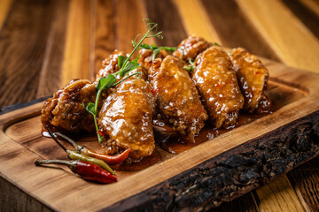 Spicy glazed chicken wings with chili and herbs
