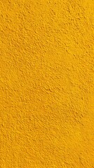 Fototapeta premium Vibrant textured yellow wall surface with subtle shadows
