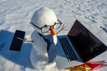 Businessman snowman talking on smartphone in snowy landscape. Snowman making a business phone call....