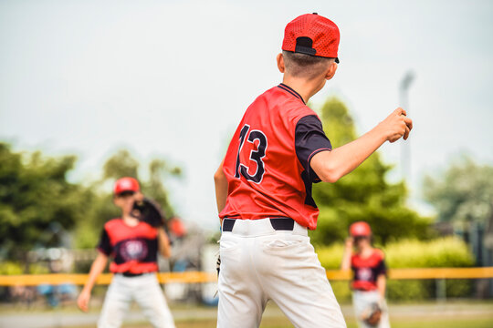 Young boy play baseball on summer day