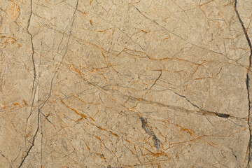 Natural stone surface showing unique patterns and textures with rich colors and veins