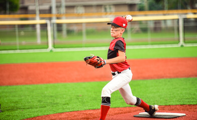 Young boy play baseball on summer day