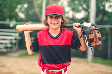 Young boy play baseball on summer day holding bat